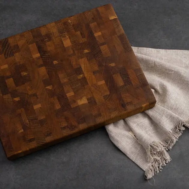 Walnut End Grain Cutting Board displayed on a grey stone table.